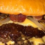 Smash burger with crispy bacon and sauteed onions Recipe Image