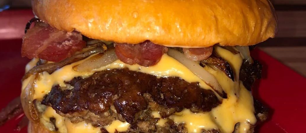 Smash burger with crispy bacon and sauteed onions