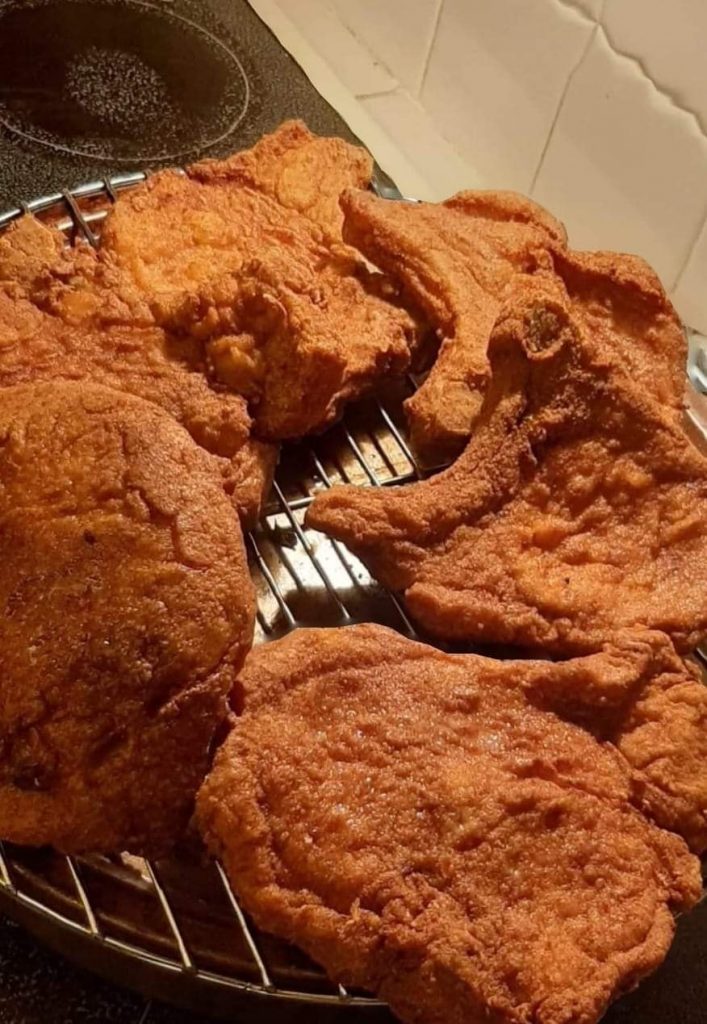 Crispy Southern fried pork chops in seasoned flour coating